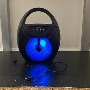 A black mini speaker it comes with the charger and can connect to any device